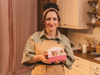 A Woman Holding a Box of Macaroons.