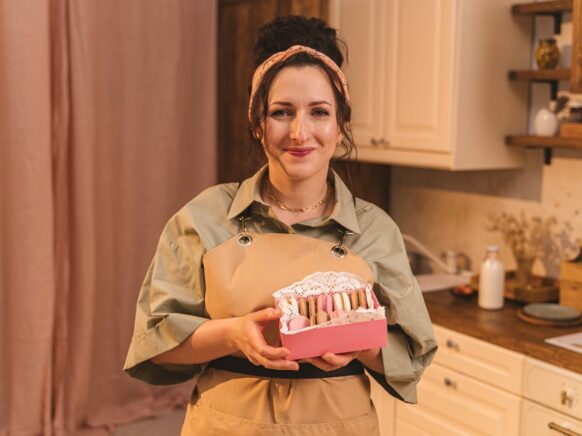 pexels-anthonyshkraba-production-8902300 A Woman Holding a Box of Macaroons.