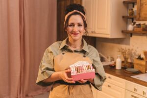 A Woman Holding a Box of Macaroons.
