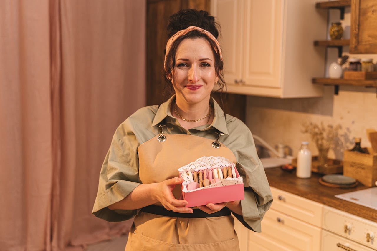 A Woman Holding a Box of Macaroons.