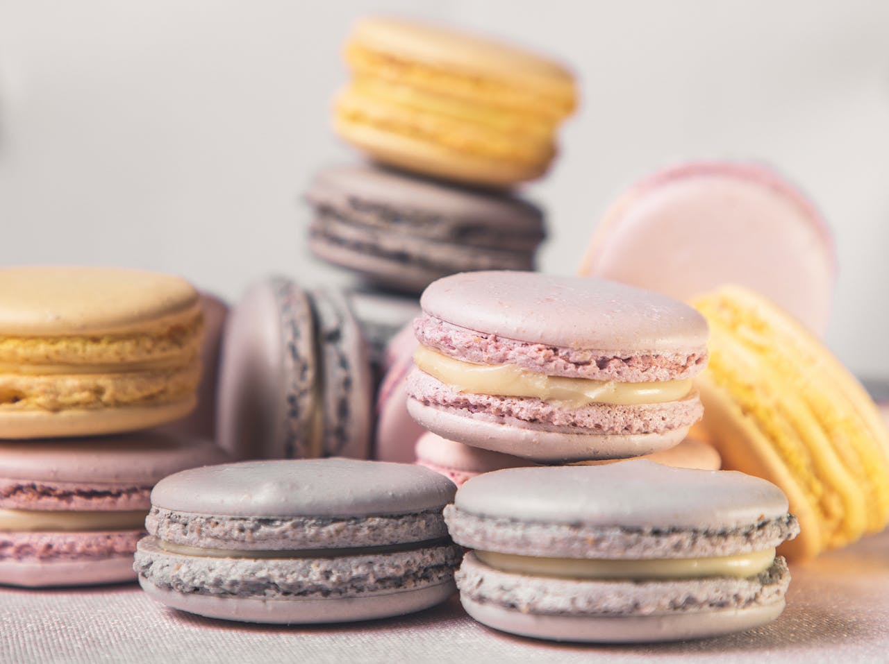 Pink, yellow, and lavender macarons stacked.