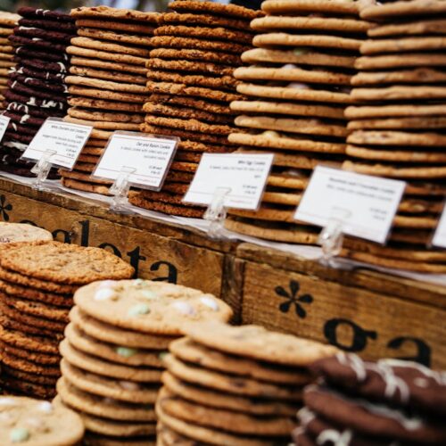 Stacks of cookies on a bakery counter.