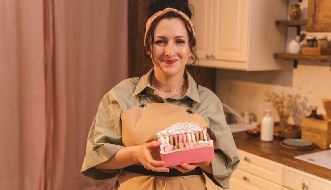 A Woman Holding a Box of Macaroons.