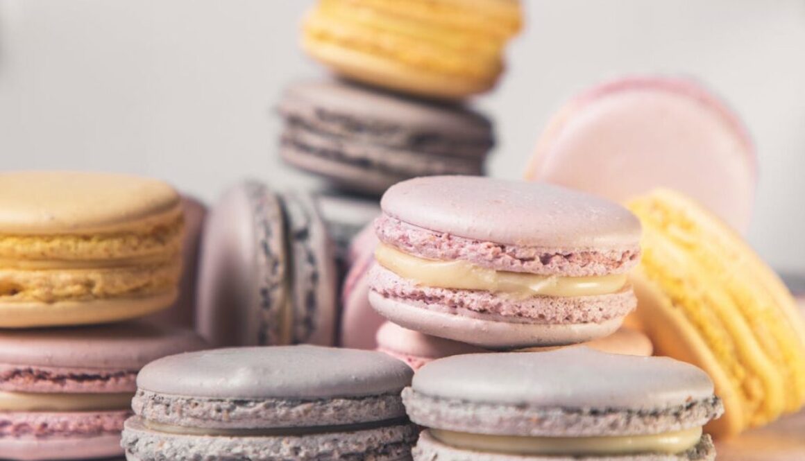 Pink, yellow, and lavender macarons stacked.